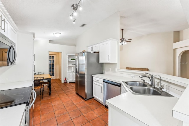 kitchen with white cabinets, sink, a textured ceiling, appliances with stainless steel finishes, and light tile patterned flooring