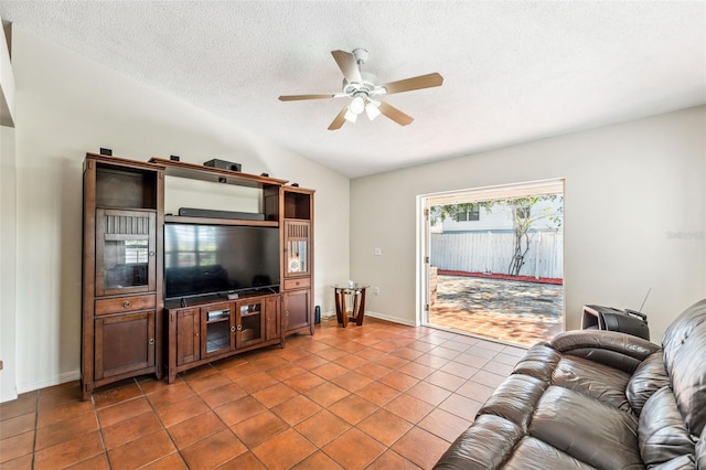 tiled living room featuring a textured ceiling, vaulted ceiling, and ceiling fan