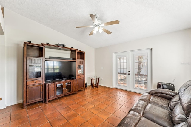 tiled living room with french doors, a textured ceiling, ceiling fan, and lofted ceiling