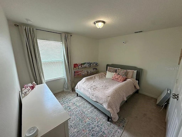 carpeted bedroom with a textured ceiling