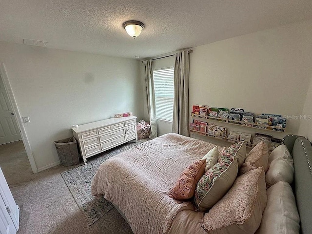 carpeted bedroom with a textured ceiling