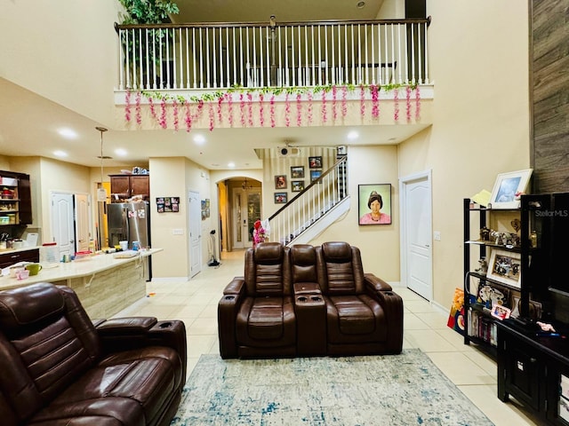 tiled living room with a high ceiling