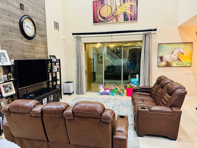 tiled living room with a towering ceiling