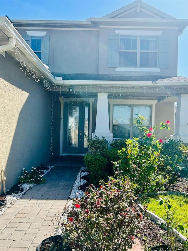 view of exterior entry with stucco siding