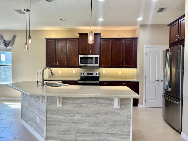 kitchen featuring a sink, visible vents, appliances with stainless steel finishes, and light tile patterned flooring