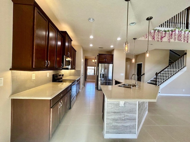 kitchen featuring a sink, stainless steel appliances, light tile patterned flooring, and decorative backsplash