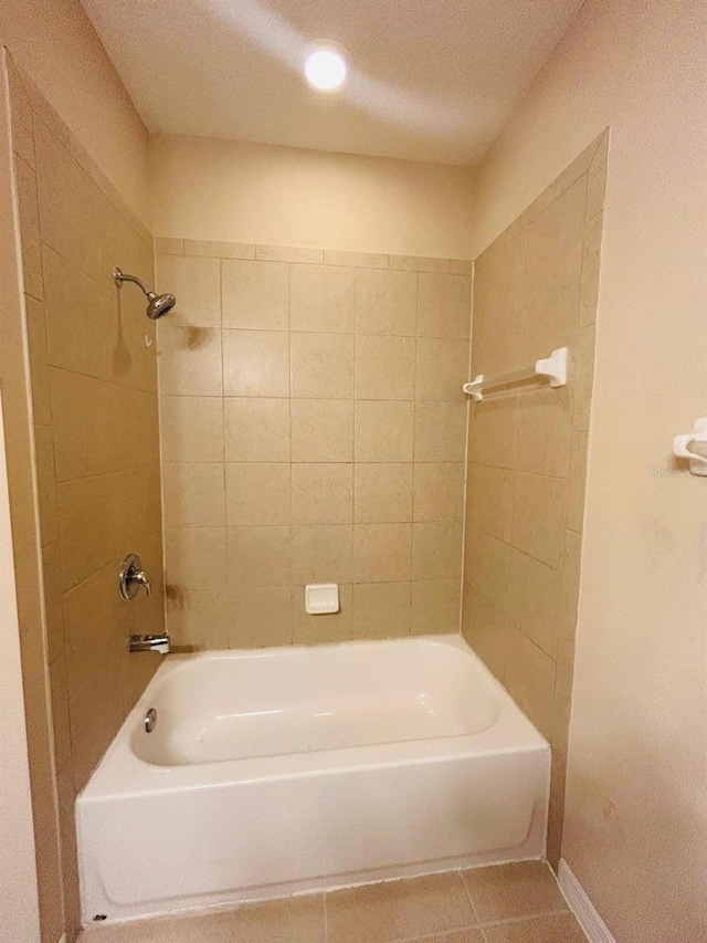 full bath with tile patterned floors, a textured ceiling,  shower combination, and baseboards