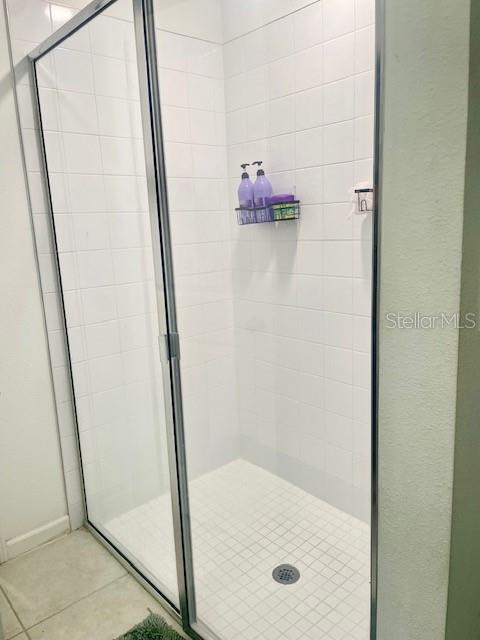 bathroom with tile patterned floors and walk in shower