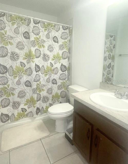 bathroom with tile patterned floors, vanity, and toilet