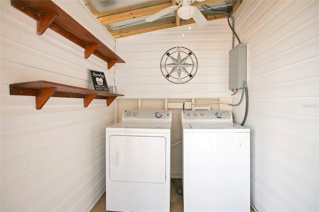 laundry room featuring washing machine and dryer and wooden walls