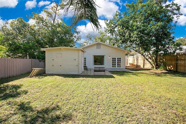 back of property featuring a lawn and a patio area