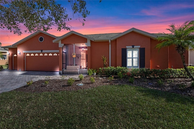 view of front facade featuring a lawn and a garage