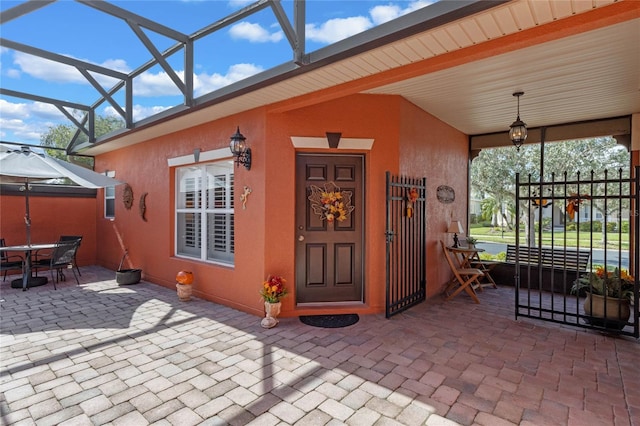 view of exterior entry with a patio