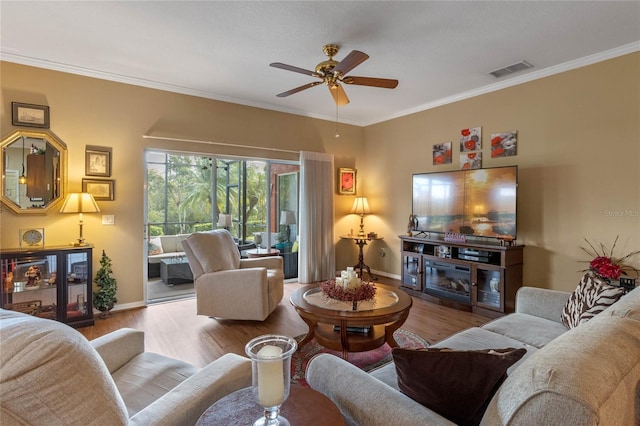 living room with ceiling fan, ornamental molding, and light hardwood / wood-style flooring