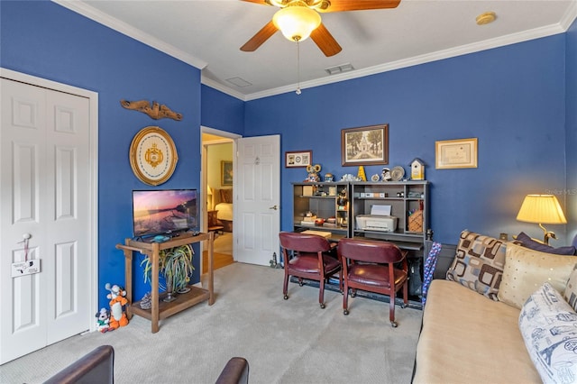 carpeted office space featuring crown molding and ceiling fan