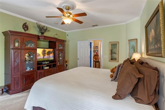 carpeted bedroom with ceiling fan and crown molding