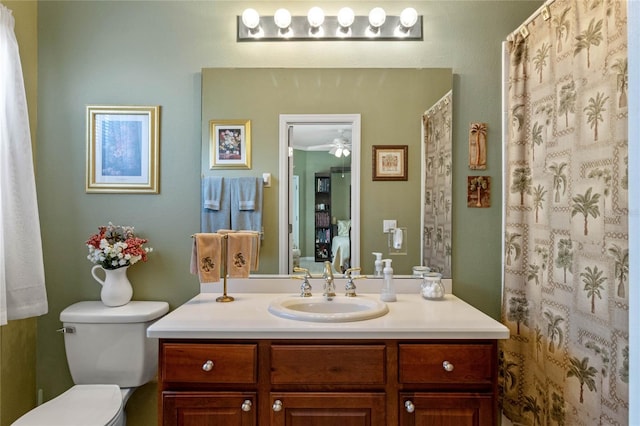 bathroom featuring vanity, ceiling fan, and toilet