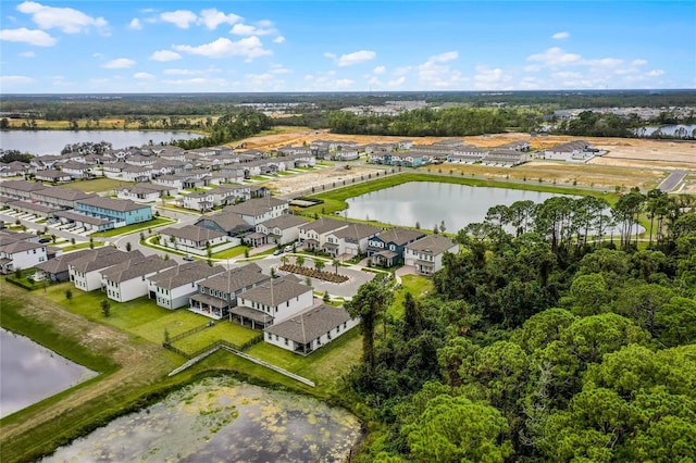 drone / aerial view with a residential view and a water view