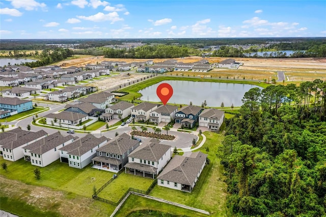 drone / aerial view with a residential view and a water view