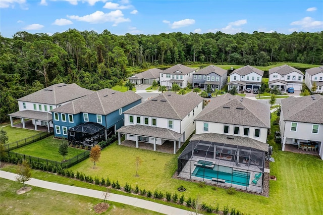 aerial view with a residential view and a view of trees