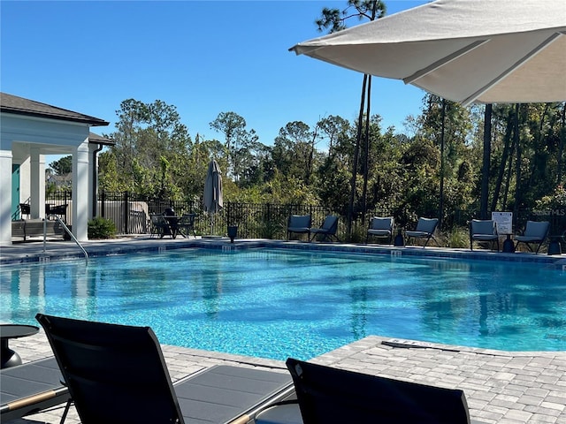 pool featuring a patio area and fence