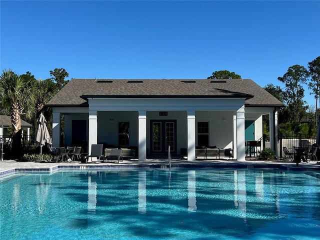 pool featuring fence, a patio, and french doors