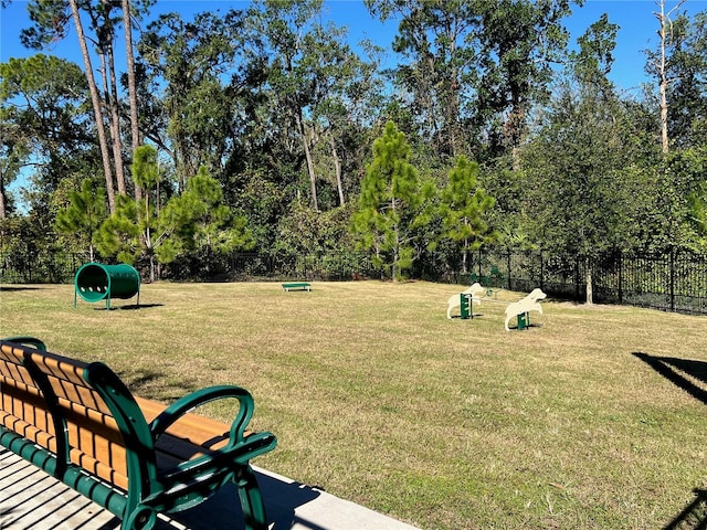 view of home's community featuring fence and a lawn