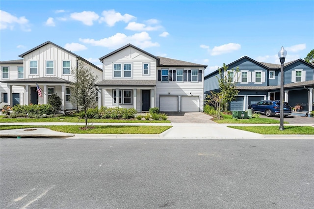 multi unit property with an attached garage and concrete driveway