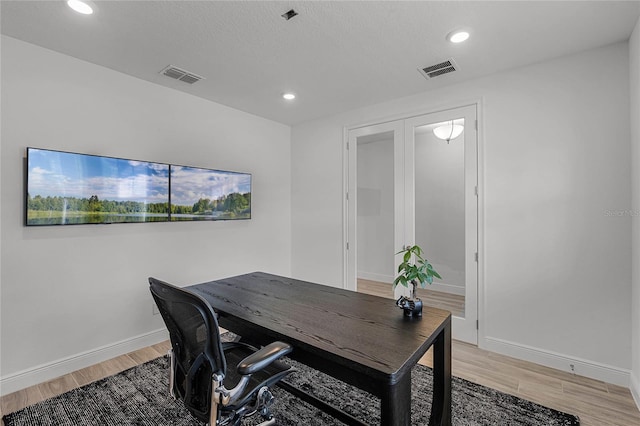 home office featuring baseboards, recessed lighting, visible vents, and light wood-style floors