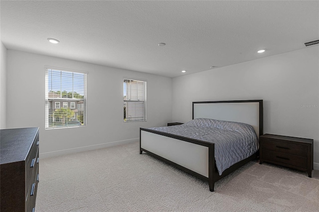 bedroom featuring light carpet, visible vents, recessed lighting, and baseboards