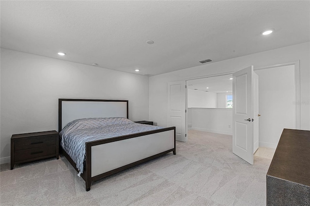 bedroom with visible vents, baseboards, light colored carpet, recessed lighting, and a textured ceiling