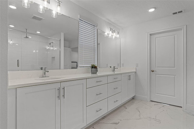 full bath featuring marble finish floor, visible vents, and a sink