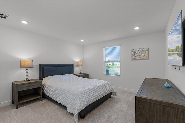 bedroom featuring recessed lighting, light colored carpet, visible vents, and baseboards