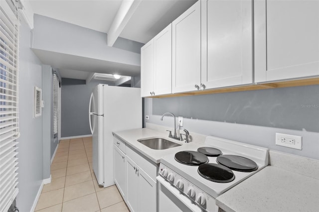 kitchen with light tile patterned floors, white appliances, white cabinetry, and sink