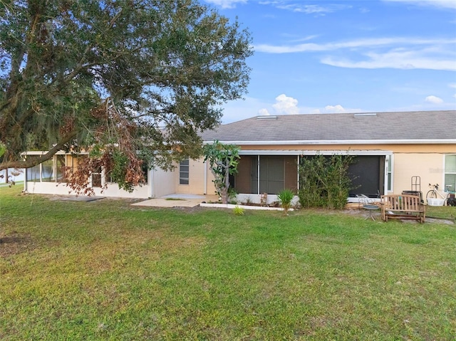 rear view of property with a yard