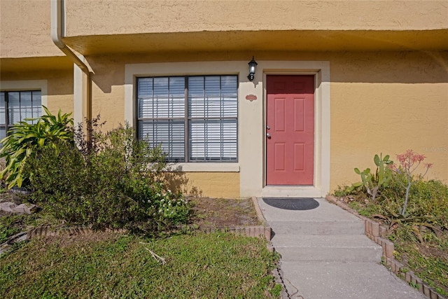 doorway to property with stucco siding