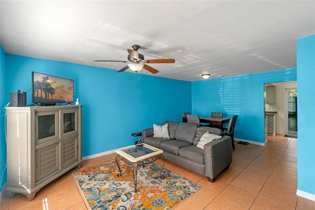 living room with ceiling fan and light tile patterned floors