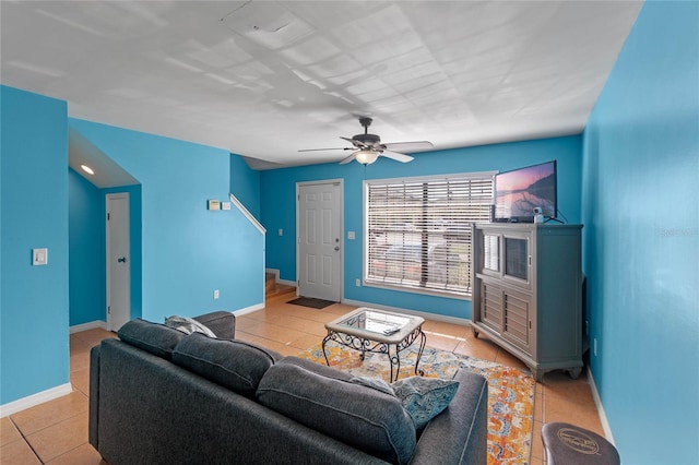 living room with ceiling fan and light tile patterned floors