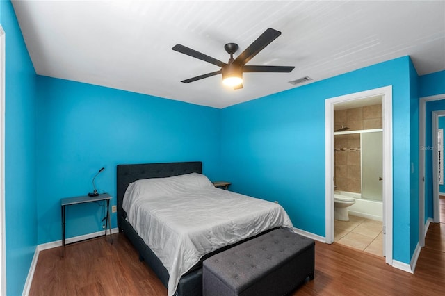 bedroom with wood-type flooring, ensuite bath, and ceiling fan