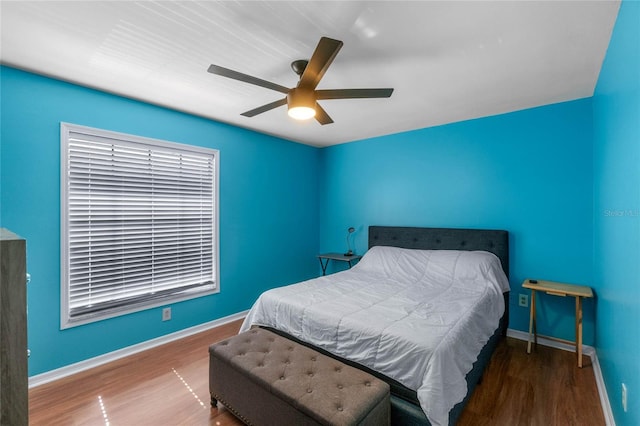 bedroom with ceiling fan and hardwood / wood-style flooring