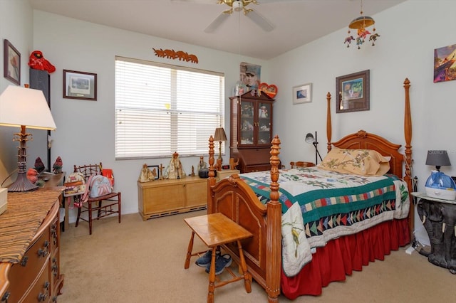 bedroom featuring ceiling fan, a baseboard radiator, and light carpet