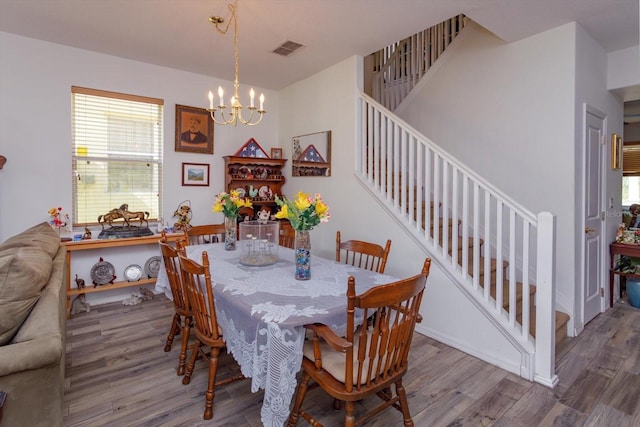 dining room featuring a chandelier and hardwood / wood-style floors