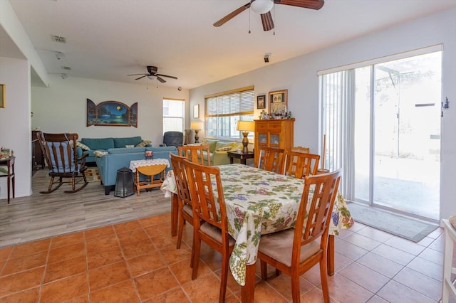 dining space with tile patterned flooring and ceiling fan