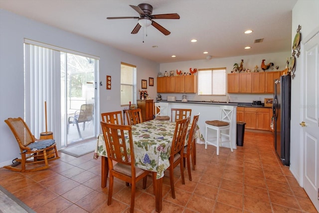 dining area with ceiling fan and light tile patterned flooring