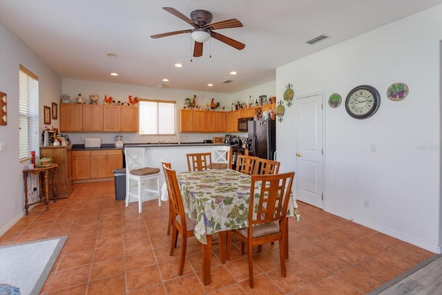 dining area featuring ceiling fan and light tile patterned floors