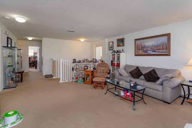 carpeted living room featuring a textured ceiling