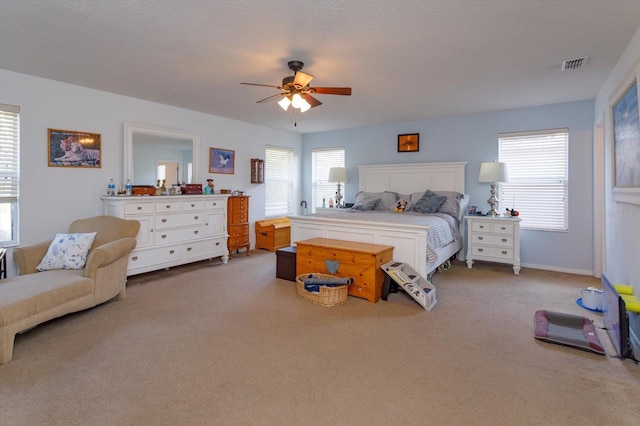 bedroom with a textured ceiling, carpet floors, and ceiling fan