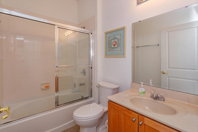 full bathroom featuring enclosed tub / shower combo, vanity, and toilet