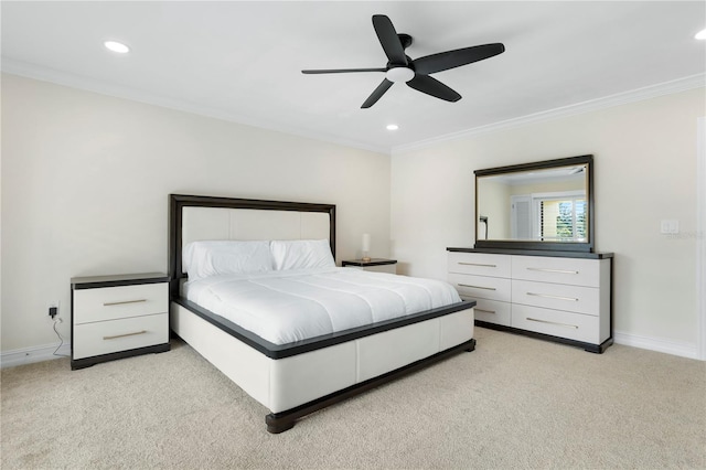 carpeted bedroom featuring ceiling fan and crown molding