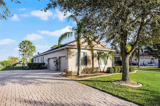 view of front facade with a garage and a front lawn